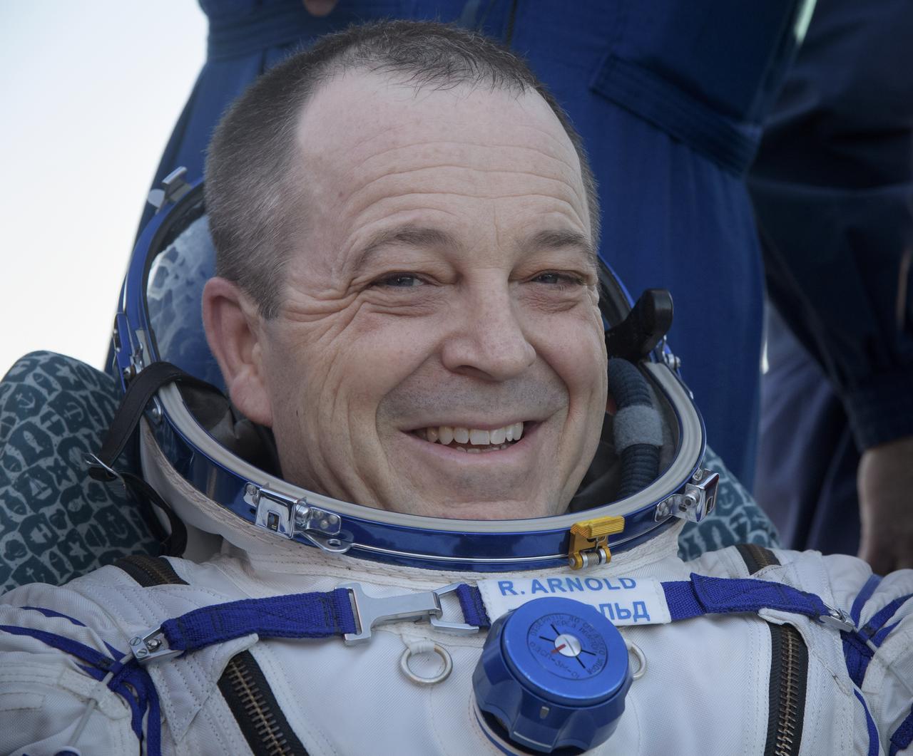 Expedition 56 Flight Engineer Ricky Arnold of NASA rests outside the Soyuz Capsule after he, Expedition 56 Commander Drew Feustel of NASA, and Expedition 56 Flight Engineer and Soyuz Commander Oleg Artemyev of Roscosmos, landed in a remote area near the town of Zhezkazgan, Kazakhstan on Thursday, Oct. 4, 2018. Feustel, Arnold, and Artemyev are returning after 197 days in space where they served as members of the Expedition 55 and 56 crews onboard the International Space Station. Photo Credit: (NASA/Bill Ingalls)