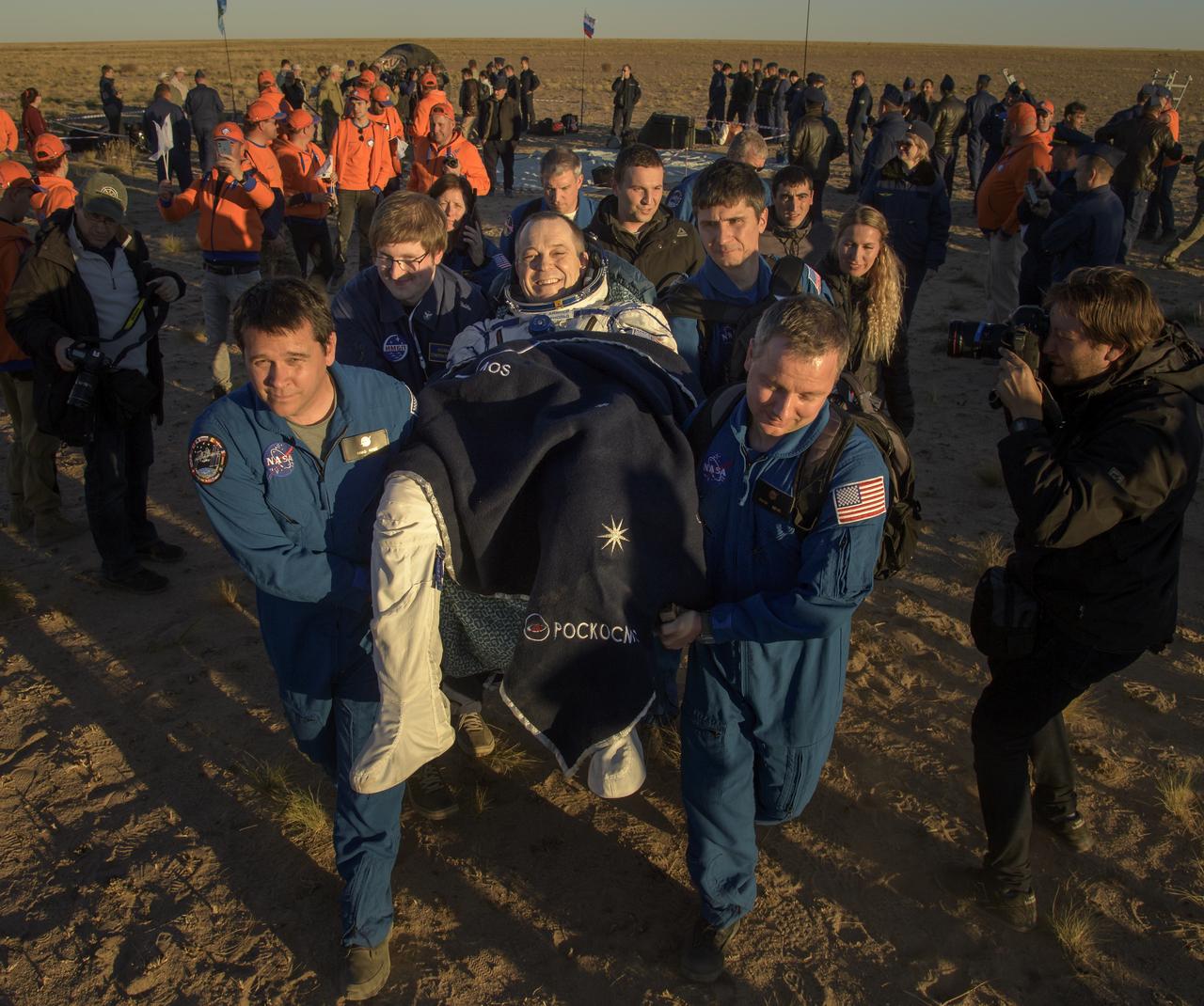 Expedition 56 Flight Engineer Ricky Arnold of NASA is carried to a medical tent shortly after he, Expedition 56 Commander Drew Feustel of NASA, and Expedition 56 Flight Engineer and Soyuz Commander Oleg Artemyev of Roscosmos landed in their Soyuz MS-08 spacecraft near the town of Zhezkazgan, Kazakhstan on Thursday, Oct. 4, 2018. Feustel, Arnold, and Artemyev are returning after 197 days in space where they served as members of the Expedition 55 and 56 crews onboard the International Space Station. Photo Credit: (NASA/Bill Ingalls)