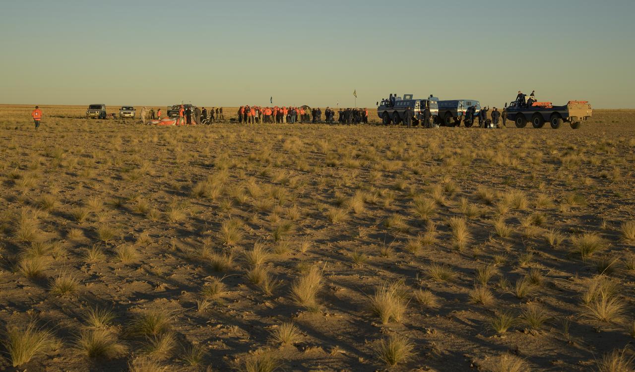 Russian support personnel work around the Soyuz MS-08 spacecraft shortly after it landed with Expedition 56 Commander Drew Feustel and Flight Engineer Ricky Arnold of NASA, along with Flight Engineer and Soyuz Commander Oleg Artemyev of Roscosmos near the town of Zhezkazgan, Kazakhstan on Thursday, Oct. 4, 2018. Feustel, Arnold, and Artemyev are returning after 197 days in space where they served as members of the Expedition 55 and 56 crews onboard the International Space Station. Photo Credit: (NASA/Bill Ingalls)