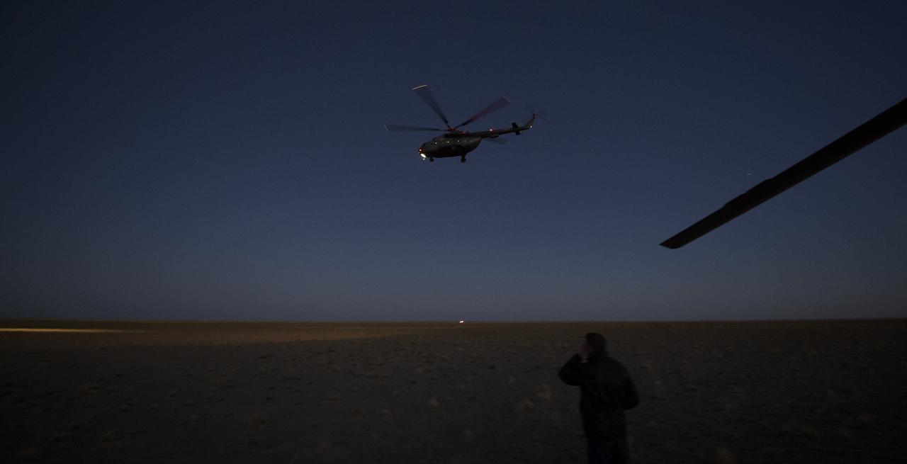 A Russian MI-8 helicopter leaves the Soyuz MS-08 spacecraft landing site after it the capsule landed with Expedition 56 Commander Drew Feustel and Flight Engineer Ricky Arnold of NASA, along with Flight Engineer and Soyuz Commander Oleg Artemyev of Roscosmos near the town of Zhezkazgan, Kazakhstan on Thursday, Oct. 4, 2018. Feustel, Arnold, and Artemyev are returning after 197 days in space where they served as members of the Expedition 55 and 56 crews onboard the International Space Station. Photo Credit: (NASA/Bill Ingalls)