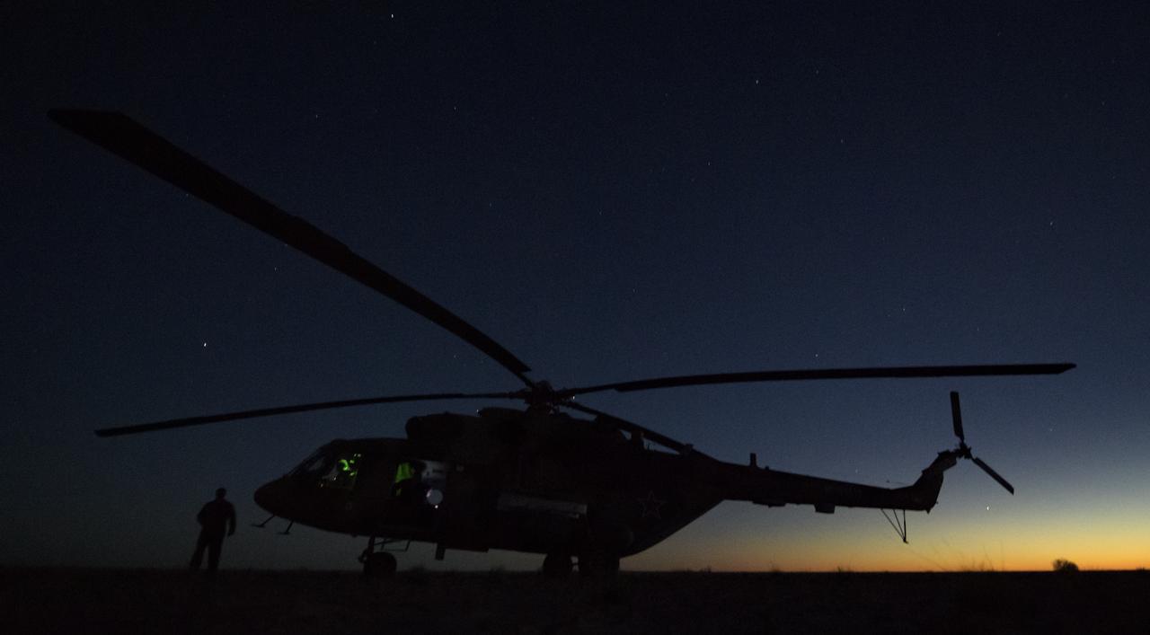 A Russian MI-8 helicopter waits to take Expedition 56 Flight Engineer Ricky Arnold of NASA from the Soyuz MS-08 landing site to the Karaganda Airport in Kazakhstan on Thursday, Oct. 4, 2018. Arnold, Expedition 56 Commander Drew Feustel of NASA, and Expedition 56 Flight Engineer and Soyuz Commander Oleg Artemyev of Roscosmos returned after 197 days in space where they served as members of the Expedition 55 and 56 crews onboard the International Space Station. Photo Credit: (NASA/Bill Ingalls)