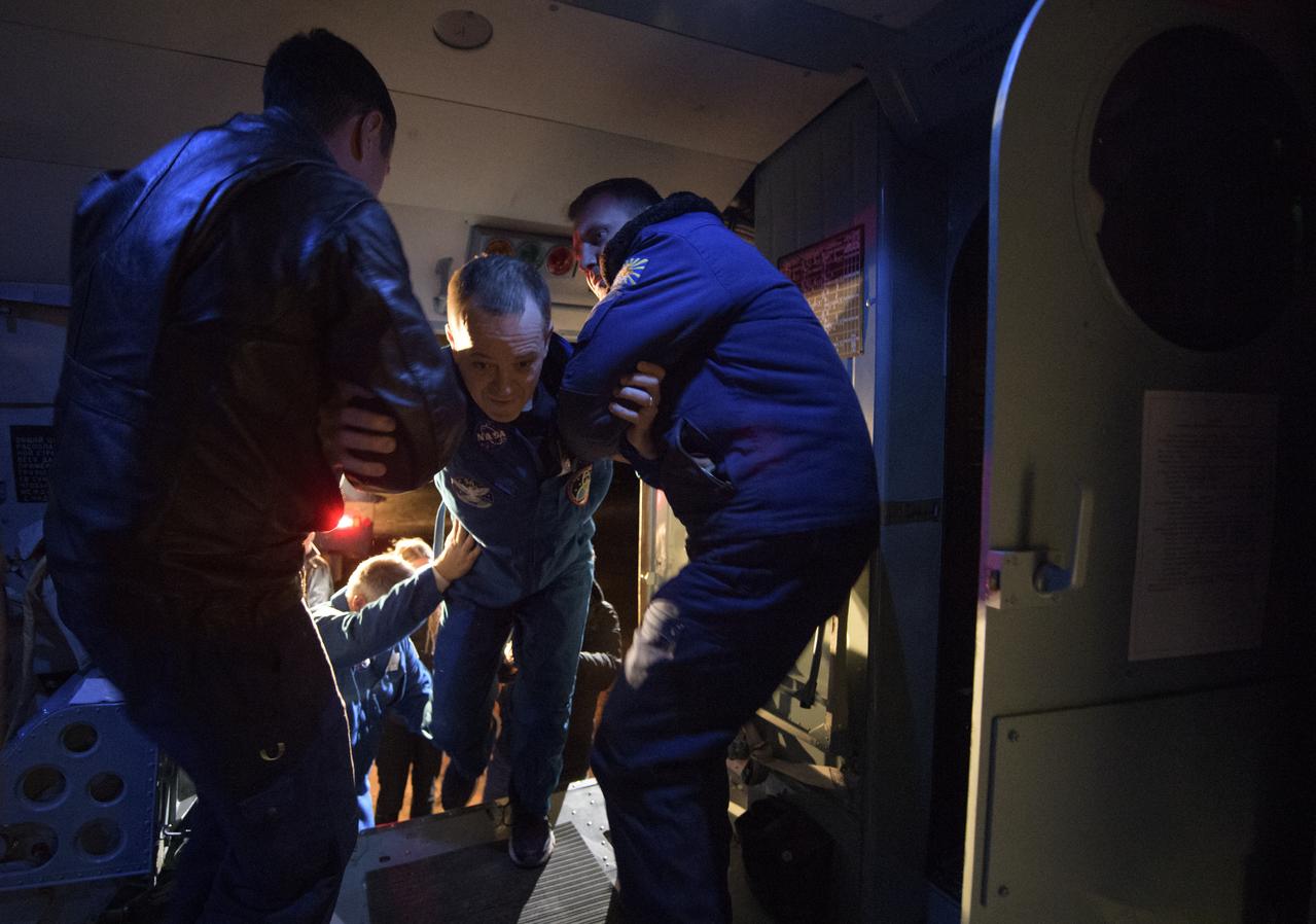 Expedition 56 Flight Engineer Ricky Arnold of NASA is helped into a helicopter shortly after he, Expedition 56 Commander Drew Feustel of NASA, and Expedition 56 Flight Engineer and Soyuz Commander Oleg Artemyev of Roscosmos landed in their Soyuz MS-08 spacecraft near the town of Zhezkazgan, Kazakhstan on Thursday, Oct. 4, 2018. Feustel, Arnold, and Artemyev are returning after 197 days in space where they served as members of the Expedition 55 and 56 crews onboard the International Space Station. Photo Credit: (NASA/Bill Ingalls)