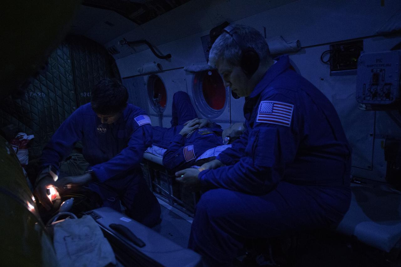 Expedition 56 Flight Engineer Ricky Arnold of NASA restss in a helicopter as Russian Nurse Artiom Kharchikov, left, and NASA Flight Surgeon Steven Piper, right look after him near the town of Zhezkazgan, Kazakhstan on Thursday, Oct. 4, 2018. Arnold, Expedition 56 Commander Drew Feustel of NASA and Expedition 56 Flight Engineer and Soyuz Commander Oleg Artemyev of Roscosmos returned to Earth after 197 days in space where they served as members of the Expedition 55 and 56 crews onboard the International Space Station. Photo Credit: (NASA/Bill Ingalls)