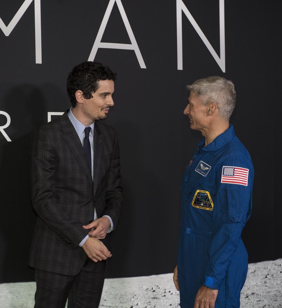 NASA astronaut Mark Vande Hei, right, speaks with Director and Producer Damien Chazelle at the premiere of Universal's feature film "First Man” Thursday, Oct. 4, 2018 at the Smithsonian National Air and Space Museum in Washington. The movie is based on the book by Jim Hansen that chronicles the life of NASA astronaut Neil Armstrong from test pilot to his historic Moon landing. It was directed by Damien Chazelle and stars Ryan Gosling and Claire Foy. Photo Credit: (NASA/Aubrey Gemignani)