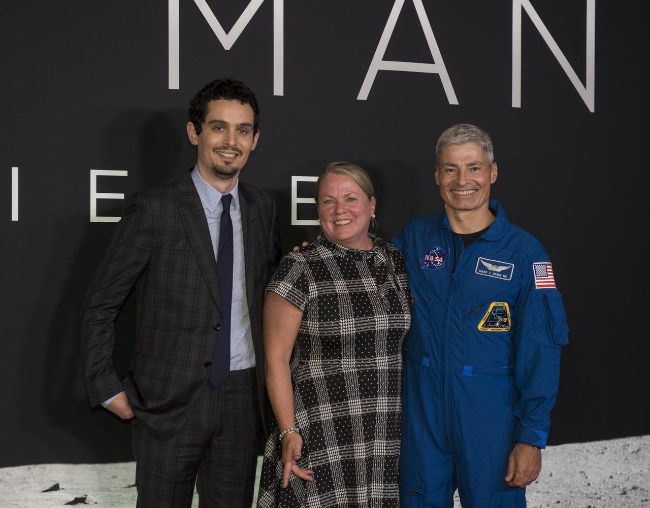 NASA astronaut Mark Vande Hei, right, and his wife Julie, center, pose for photo with Director and Producer Damien Chazelle at the premiere of Universal's feature film "First Man” Thursday, Oct. 4, 2018 at the Smithsonian National Air and Space Museum in Washington. The movie is based on the book by Jim Hansen that chronicles the life of NASA astronaut Neil Armstrong from test pilot to his historic Moon landing. It was directed by Damien Chazelle and stars Ryan Gosling and Claire Foy. Photo Credit: (NASA/Aubrey Gemignani)