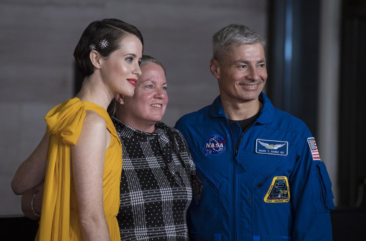 NASA astronaut Mark Vande Hei, right, and his wife Julie, center, pose for a photo with English actress Claire Foy, at the premiere of Universal's feature film "First Man” Thursday, Oct. 4, 2018 at the Smithsonian National Air and Space Museum in Washington. The movie is based on the book by Jim Hansen that chronicles the life of NASA astronaut Neil Armstrong from test pilot to his historic Moon landing. It was directed by Damien Chazelle and stars Ryan Gosling and Claire Foy. Photo Credit: (NASA/Aubrey Gemignani)