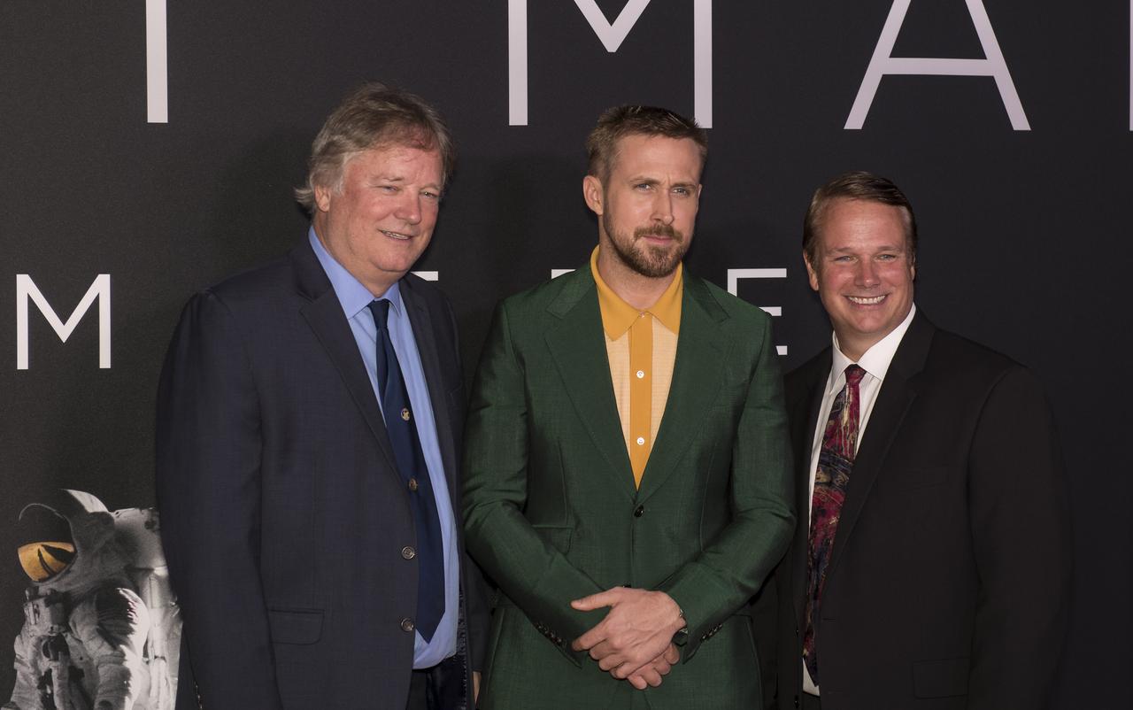 Canadian actor Ryan Gosling, center, poses for a photo with Neil Armstrong's sons, Rick, left, and Mark, right after arriving on the red carpet for the premiere of the film "First Man" at the Smithsonian National Air and Space Museum Thursday, Oct. 4, 2018 in Washington. The film is based on the book by Jim Hansen, and chronicles the life of NASA astronaut Neil Armstrong from test pilot to his historic Moon landing. Photo Credit: (NASA/Aubrey Gemignani)