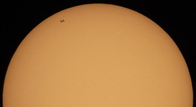 The International Space Station, with a crew of three onboard, is seen in silhouette as it transits the Sun at roughly five miles per second, Sunday, Oct. 7, 2018 from Suffolk, Va. Onboard are Expedition 57 Commander Alexander Gerst of ESA (European Space Agency), Serena Auñón-Chancellor of NASA, and Sergey Prokopyev of Roscosmos. The trio will soon be joined by Nick Hague of NASA and Alexey Ovchinin of Roscosmos, who are scheduled to launch on October 11 from the Baikonur Cosmodrome in Kazakhstan. Photo Credit: (NASA/Joel Kowsky)