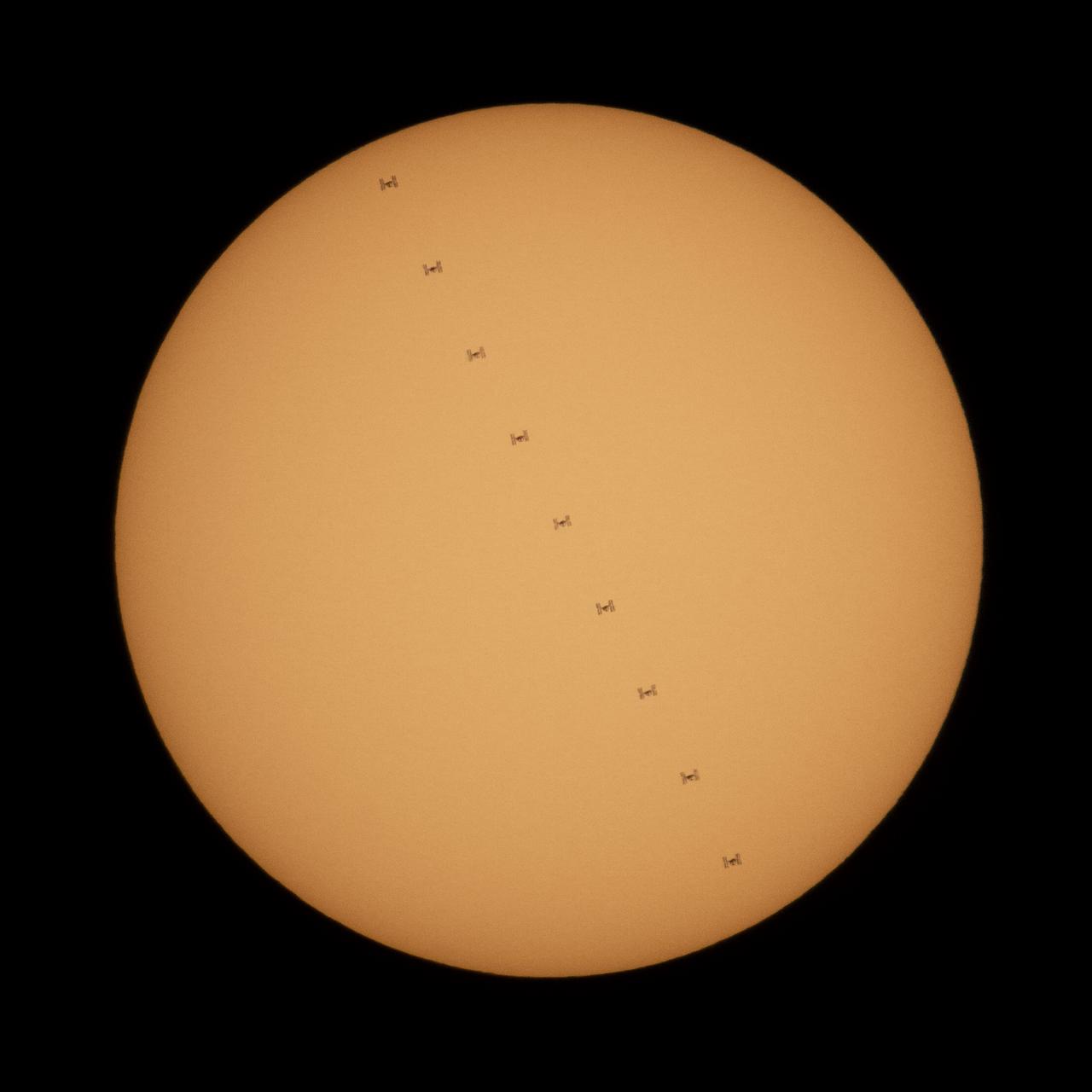 This composite image, made from nine frames, shows the International Space Station, with a crew of three onboard, in silhouette as it transits the Sun at roughly five miles per second, Sunday, Oct. 7, 2018 from Suffolk, Va. Onboard are Expedition 57 Commander Alexander Gerst of ESA (European Space Agency), Serena Auñón-Chancellor of NASA, and Sergey Prokopyev of Roscosmos. The trio will soon be joined by Nick Hague of NASA and Alexey Ovchinin of Roscosmos, who are scheduled to launch on October 11 from the Baikonur Cosmodrome in Kazakhstan. Photo Credit: (NASA/Joel Kowsky)