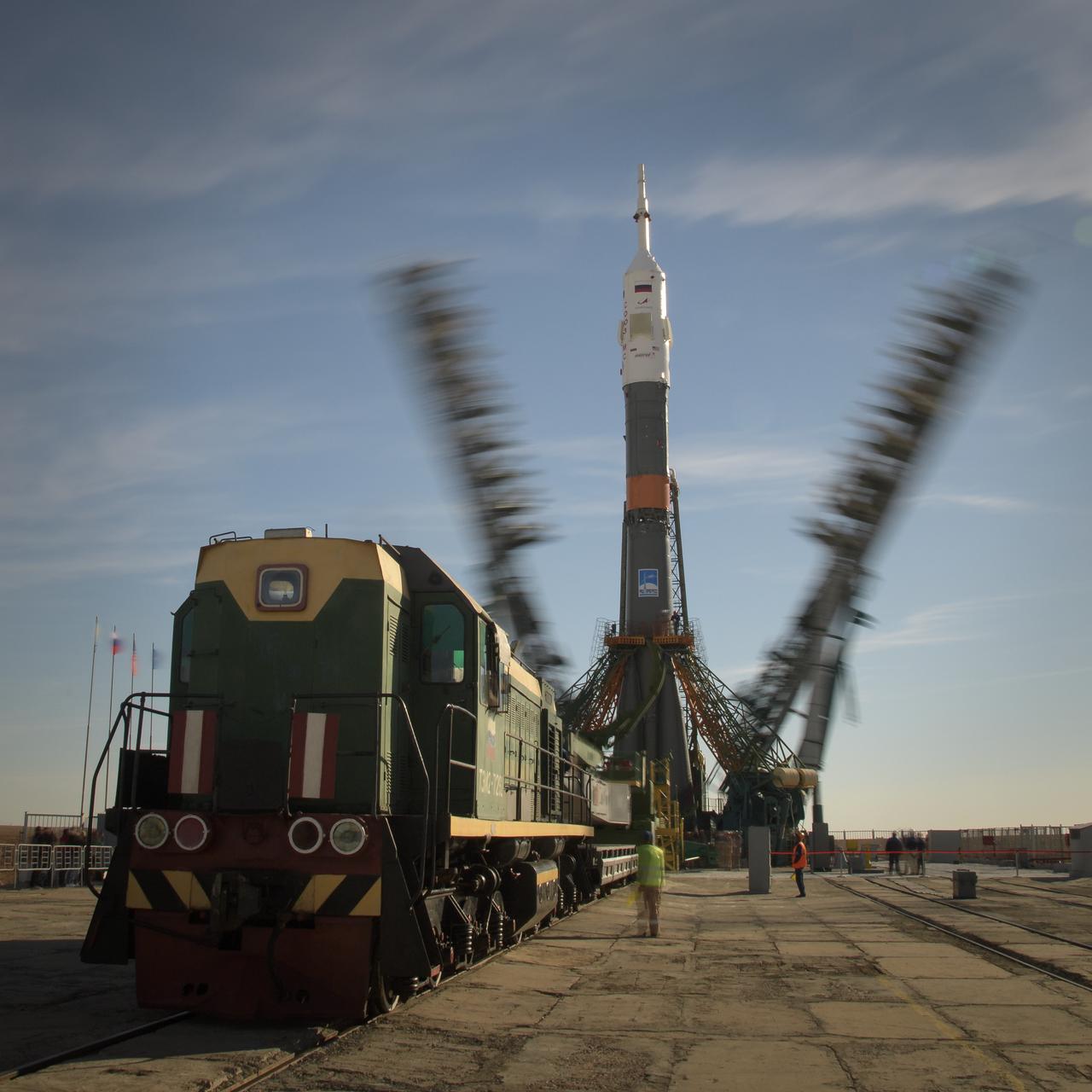 The gantry arms are seen closing around the Soyuz rocket in this long exposure photograph, Tuesday, Oct. 9, 2018 at the Baikonur Cosmodrome in Kazakhstan. Expedition 57 crewmembers Nick Hague of NASA and Alexey Ovchinin of Roscosmos are scheduled to launch on October 11 and will spend the next six months living and working aboard the International Space Station. Photo Credit: (NASA/Bill Ingalls)