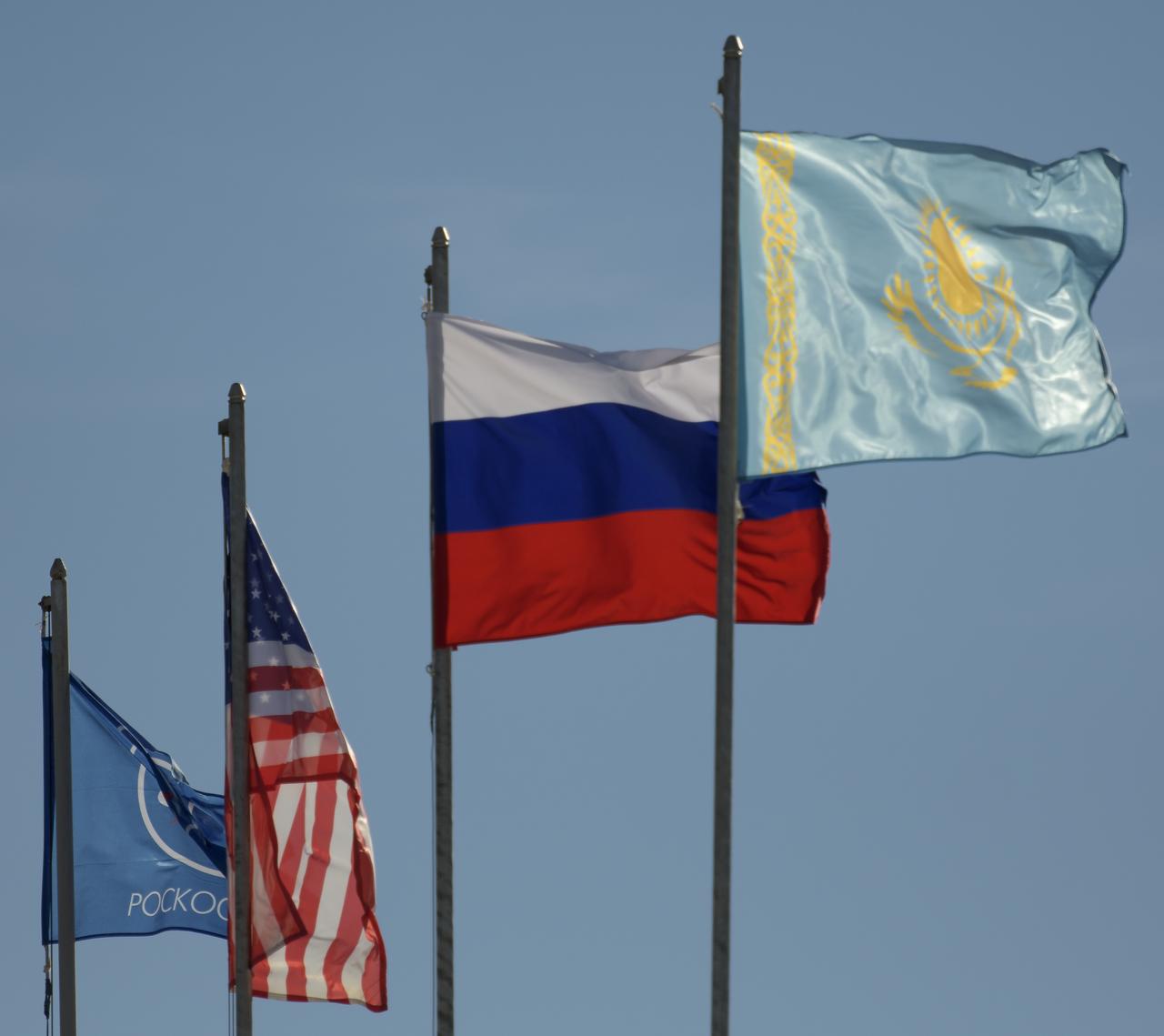 The flags of Roscosmos, The United States, Russia, and Kazakhstan are seen at the Soyuz Launch, Tuesday, Oct. 9, 2018 at the Baikonur Cosmodrome in Kazakhstan. Expedition 57 crewmembers Nick Hague of NASA and Alexey Ovchinin of Roscosmos are scheduled to launch on October 11 and will spend the next six months living and working aboard the International Space Station. Photo Credit: (NASA/Bill Ingalls)