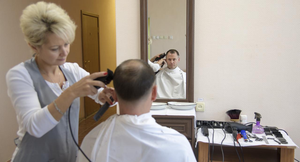 Expedition 57 Flight Engineer Nick Hague of NASA gets his hair cut, Tuesday, Oct. 9, 2018 at the Cosmonaut Hotel in Baikonur, Kazakhstan. Hague and Expedition 57 Flight Engineer Alexey Ovchinin of Roscosmos are scheduled to launch onboard a Soyuz rocket October 11 and will spend the next six months living and working aboard the International Space Station. Photo Credit: (NASA/Bill Ingalls)