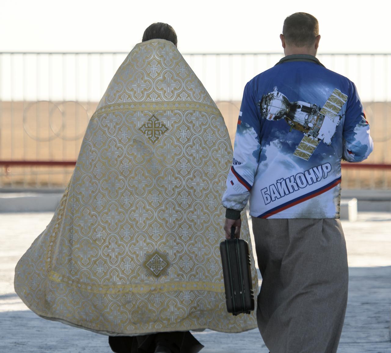 Russian Orthodox Priest, Father Sergei, left, blesses the Soyuz rocket at the Baikonur Cosmodrome launch pad, Wednesday, Oct. 10, 2018 in Baikonur, Kazakhstan. Expedition 57 crewmembers Nick Hague of NASA and Alexey Ovchinin of Roscosmos are scheduled to launch on October 11 and will spend the next six months living and working aboard the International Space Station. Photo Credit: (NASA/Bill Ingalls)