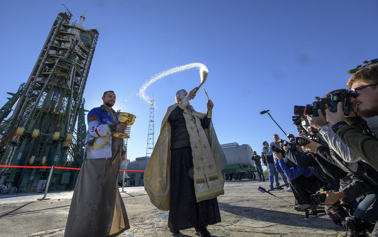 Russian Orthodox Priest, Father Sergei, blesses members of the media after having blessed the Soyuz rocket at the Baikonur Cosmodrome launch pad, Wednesday, Oct. 10, 2018 in Baikonur, Kazakhstan. Expedition 57 crewmembers Nick Hague of NASA and Alexey Ovchinin of Roscosmos are scheduled to launch on October 11 and will spend the next six months living and working aboard the International Space Station. Photo Credit: (NASA/Bill Ingalls)