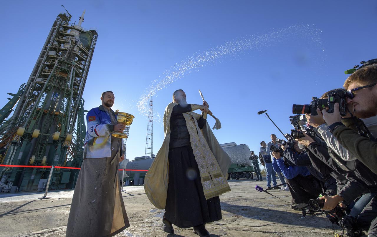 Russian Orthodox Priest, Father Sergei, blesses members of the media after having blessed the Soyuz rocket at the Baikonur Cosmodrome launch pad, Wednesday, Oct. 10, 2018 in Baikonur, Kazakhstan. Expedition 57 crewmembers Nick Hague of NASA and Alexey Ovchinin of Roscosmos are scheduled to launch on October 11 and will spend the next six months living and working aboard the International Space Station. Photo Credit: (NASA/Bill Ingalls)