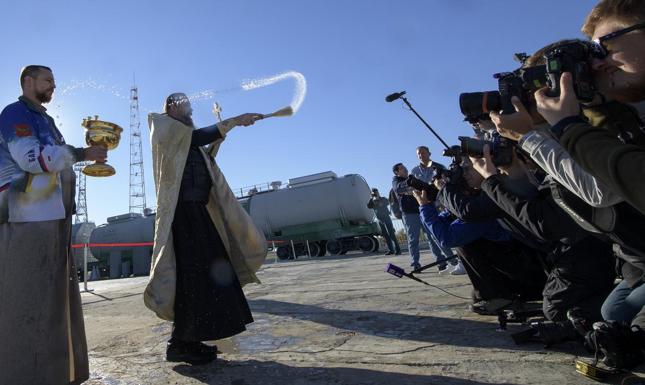 Russian Orthodox Priest, Father Sergei, blesses members of the media after having blessed the Soyuz rocket at the Baikonur Cosmodrome launch pad, Wednesday, Oct. 10, 2018 in Baikonur, Kazakhstan. Expedition 57 crewmembers Nick Hague of NASA and Alexey Ovchinin of Roscosmos are scheduled to launch on October 11 and will spend the next six months living and working aboard the International Space Station. Photo Credit: (NASA/Bill Ingalls)