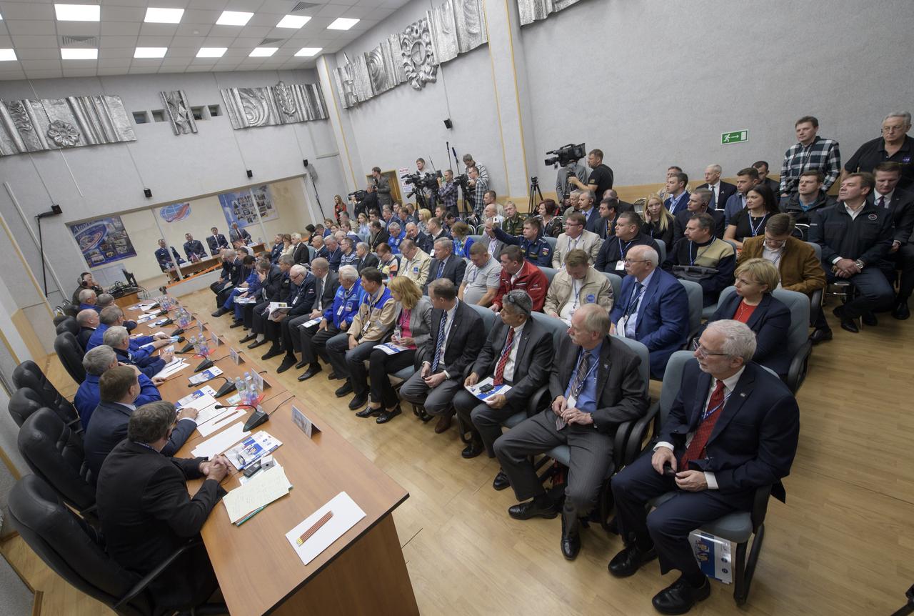 Expedition 57 prime crew members Nick Hague, left, Alexey Ovchinin, second from left, are seen in quarantine behind glass with backup crew members Oleg Kononenko, and David Saint-Jacques, right, during the State Commission meeting to approve the Soyuz launch of Expedition 57 to the International Space Station, Wednesday, Oct. 10, 2018 at the Cosmonaut Hotel in  Baikonur, Kazakhstan. Hague and Ovchinin are scheduled to launch on October 11 and will spend the next six months living and working aboard the International Space Station. Photo Credit: (NASA/Bill Ingalls)