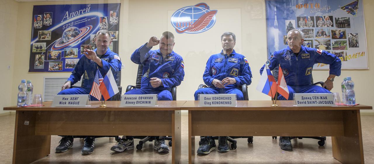 Expedition 57 prime crew members Nick Hague, left, Alexey Ovchinin, second from left, are seen in quarantine with backup crew members Oleg Kononenko, and David Saint-Jacques, right, during a press conference, Wednesday, Oct. 10, 2018 at the Cosmonaut Hotel in Baikonur, Kazakhstan. Hague and Ovchinin are scheduled to launch on October 11 and will spend the next six months living and working aboard the International Space Station. Photo Credit: (NASA/Bill Ingalls)