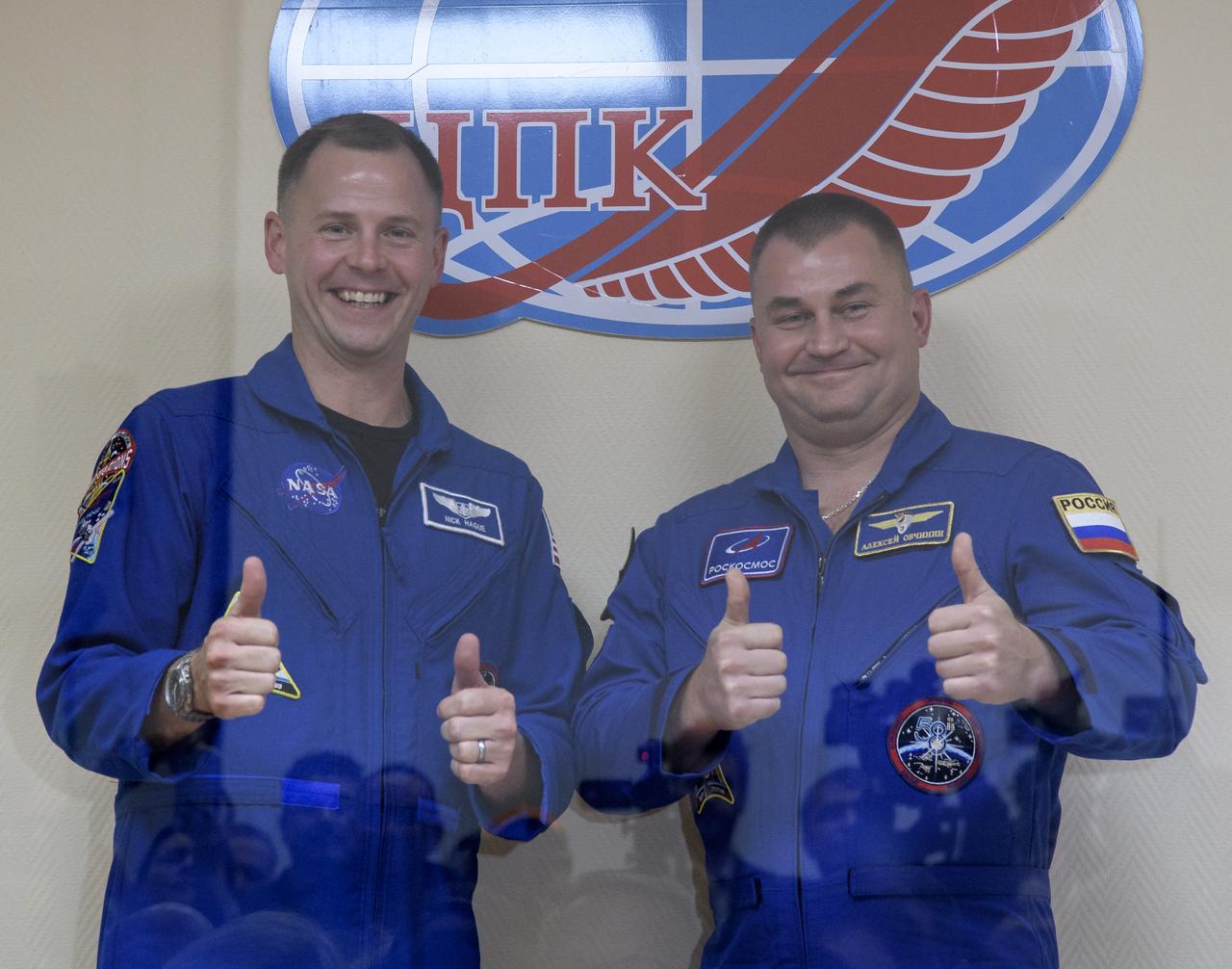 Expedition 57 Flight Engineer Nick Hague of NASA, left, and Flight Engineer Alexey Ovchinin of Roscosmos pose for a photo following a crew press conference, Wednesday, Oct. 10, 2018 at the Cosmonaut Hotel in Baikonur, Kazakhstan. Hague and Ovchinin are scheduled to launch on October 11 and will spend the next six months living and working aboard the International Space Station. Photo Credit: (NASA/Bill Ingalls)