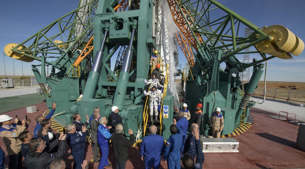 Expedition 57 Flight Engineer Nick Hague of NASA, top, and Flight Engineer Alexey Ovchinin of Roscosmos, wave farewell prior to boarding the Soyuz MS-10 spacecraft for launch, Thursday, Oct. 11, 2018 at the Baikonur Cosmodrome in Kazakhstan. Hague and Ovchinin will spend the next six months living and working aboard the International Space Station. Photo Credit: (NASA/Bill Ingalls)