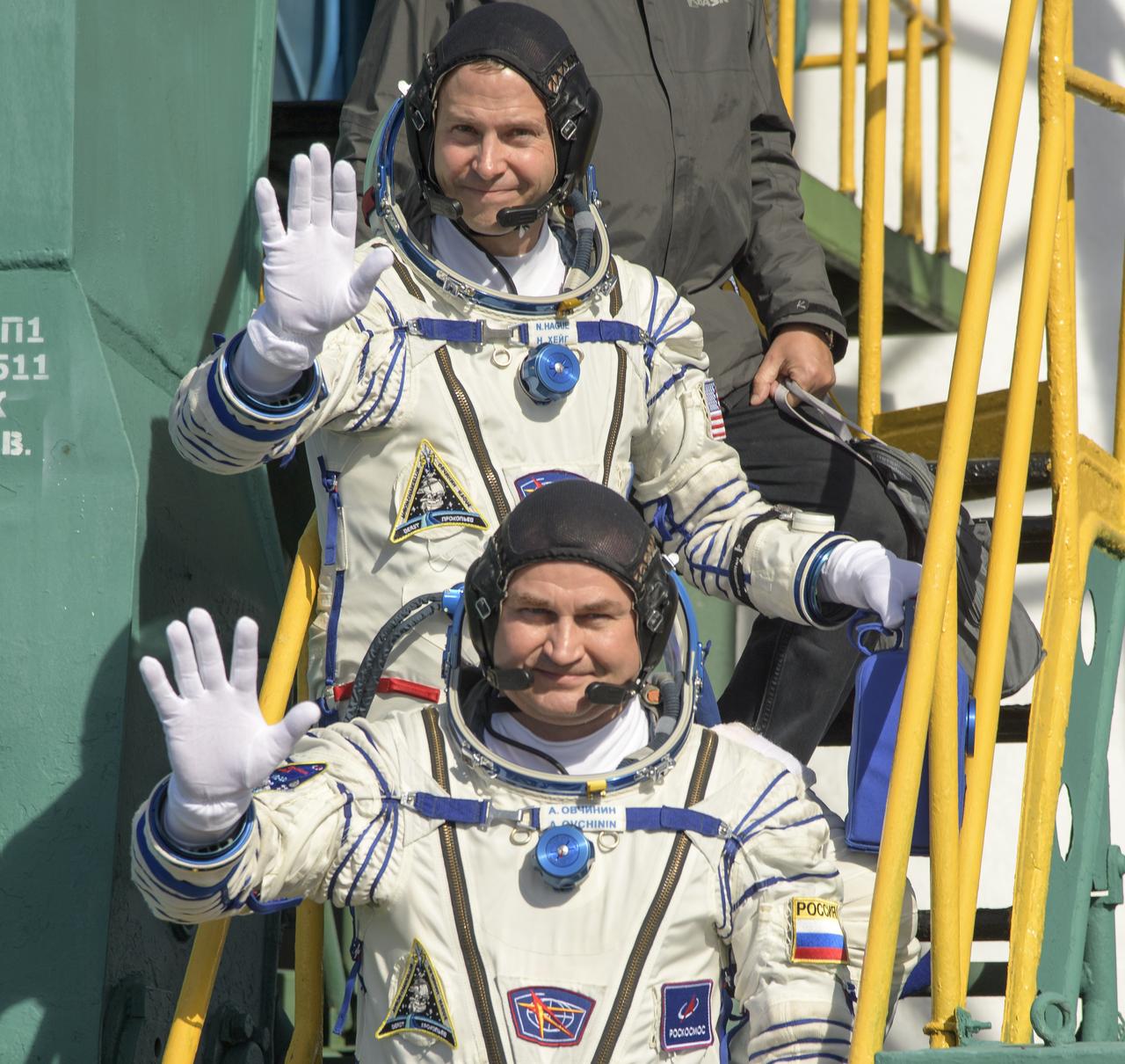 Expedition 57 Flight Engineer Nick Hague of NASA, top, and Flight Engineer Alexey Ovchinin of Roscosmos, wave farewell prior to boarding the Soyuz MS-10 spacecraft for launch, Thursday, Oct. 11, 2018 at the Baikonur Cosmodrome in Kazakhstan. Hague and Ovchinin will spend the next six months living and working aboard the International Space Station. Photo Credit: (NASA/Bill Ingalls)