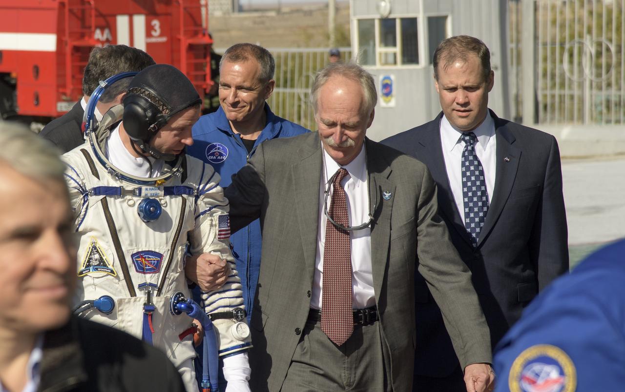 Expedition 57 Flight Engineer Nick Hague of NASA walks with NASA Associate Administrator for the Human Exploration and Operations Directorate William Gerstenmaier, center, and NASA Administrator Jim Bridenstine, right, prior to boarding the Soyuz MS-10 spacecraft for launch, Thursday, Oct. 11, 2018 at the Baikonur Cosmodrome in Kazakhstan. Hague and Expedition 57 Flight Engineer Alexey Ovchinin of Roscosmos will spend the next six months living and working aboard the International Space Station. Photo Credit: (NASA/Bill Ingalls)