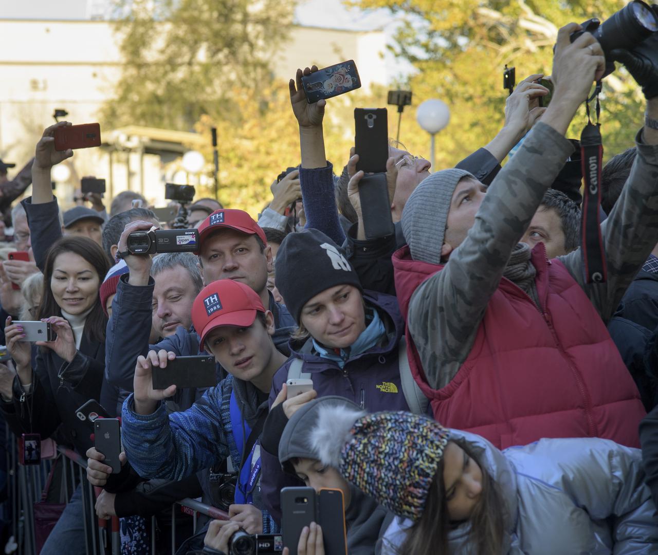 Crowds await the Cosmonaut Hotel departure of Expedition 57 Flight Engineer Alexey Ovchinin of Roscosmos, and Flight Engineer Nick Hague of NASA to building 254 to suit-up for their Soyuz launch to the International Space Station, Thursday, Oct. 11, 2018 in Baikonur, Kazakhstan. During the Soyuz spacecraft's climb to orbit, an anomaly occurred, resulting in an abort downrange. The crew was quickly recovered and is in good condition. Photo Credit: (NASA/Bill Ingalls)