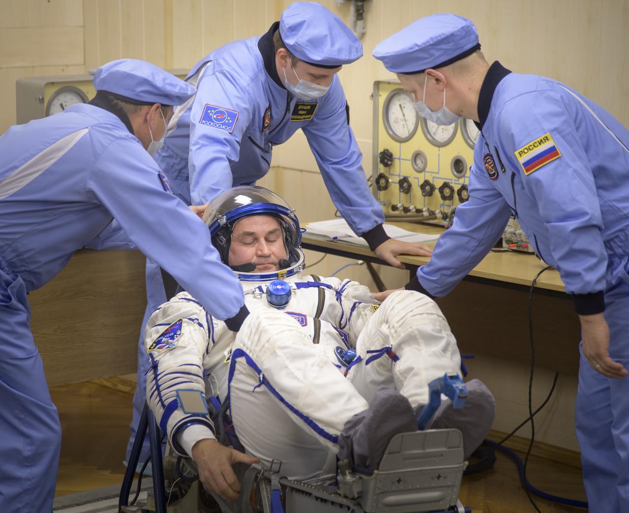 Expedition 57 Flight Engineer Alexey Ovchinin of Roscosmos has his Sokol suit pressure checked a few hours ahead of his launch on a Soyuz rocket with Flight Engineer Nick Hague of NASA, Thursday, Oct. 11, 2018 at the Baikonur Cosmodrome in Kazakhstan. During the Soyuz spacecraft's climb to orbit, an anomaly occurred, resulting in an abort downrange. The crew was quickly recovered and is in good condition. Photo Credit: (NASA/Bill Ingalls)