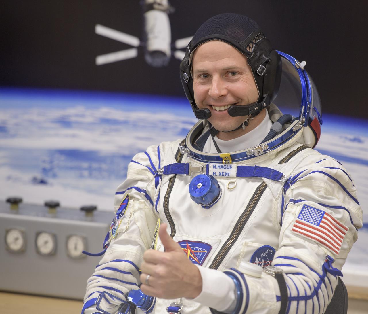 Expedition 57 Flight Engineer Nick Hague of NASA gives a thumbs up as he waits to have his Sokol suit pressure checked ahead of his launch on a Soyuz rocket with Flight Engineer Alexey Ovchinin of Roscosmos, Thursday, Oct. 11, 2018 at the Baikonur Cosmodrome in Kazakhstan. During the Soyuz spacecraft's climb to orbit, an anomaly occurred, resulting in an abort downrange. The crew was quickly recovered and is in good condition. Photo Credit: (NASA/Bill Ingalls)