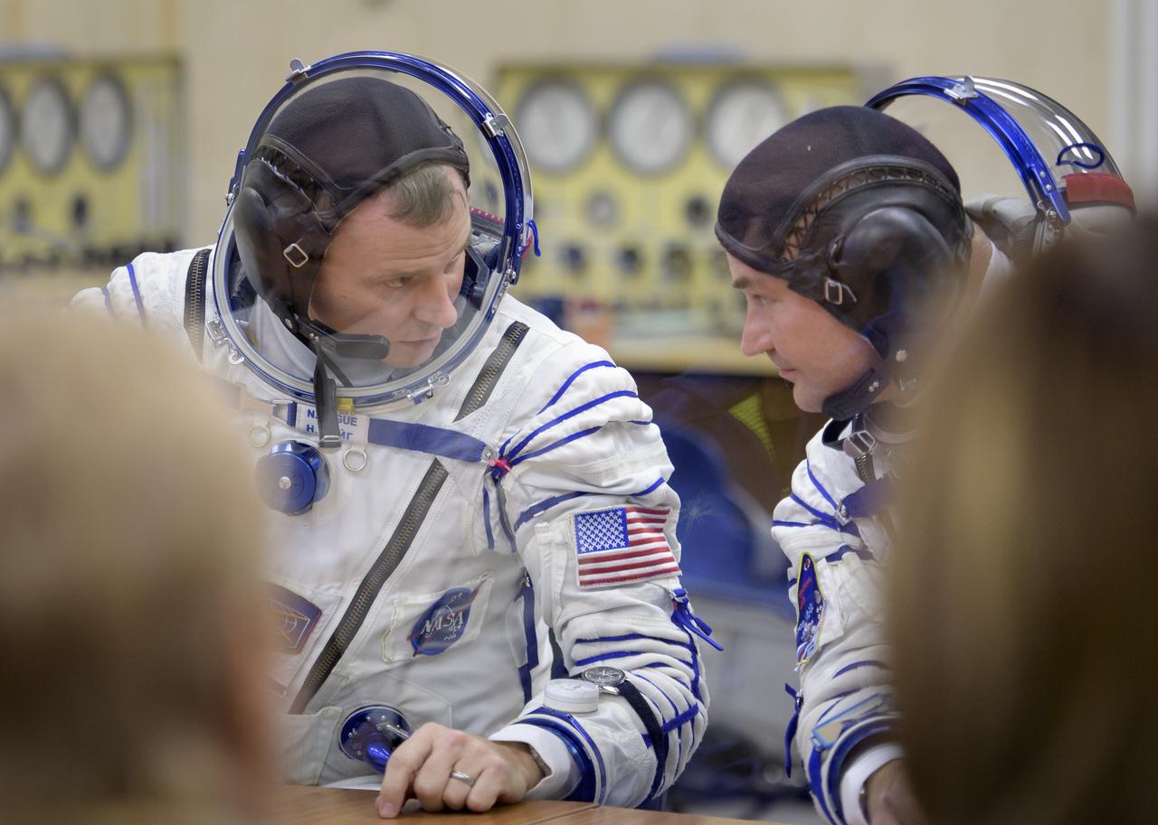 Expedition 57 Flight Engineer Nick Hague of NASA, left, and Flight Engineer Alexey Ovchinin of Roscosmos talk after their Sokol suit pressure checks ahead of their launch on a Soyuz rocket, Thursday, Oct. 11, 2018 at the Baikonur Cosmodrome in Kazakhstan. During the Soyuz spacecraft's climb to orbit, an anomaly occurred, resulting in an abort downrange. The crew was quickly recovered and is in good condition. Photo Credit: (NASA/Bill Ingalls)