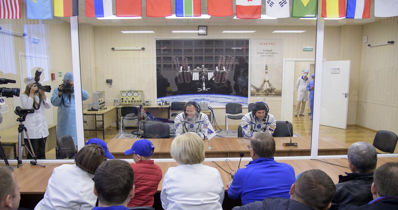 Expedition 57 Flight Engineer Nick Hague of NASA, left, and Flight Engineer Alexey Ovchinin of Roscosmos talk with their families after having their Sokol suits pressure checked ahead of their launch on a Soyuz rocket, Thursday, Oct. 11, 2018 at the Baikonur Cosmodrome in Kazakhstan. During the Soyuz spacecraft's climb to orbit, an anomaly occurred, resulting in an abort downrange. The crew was quickly recovered and is in good condition. Photo Credit: (NASA/Bill Ingalls)