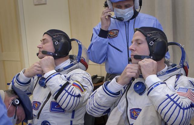 Expedition 57 Flight Engineer Alexey Ovchinin of Roscosmos, left, and Flight Engineer Nick Hague of NASA dons their Sokol suits ahead of their launch on a Soyuz rocket, Thursday, Oct. 11, 2018 at the Baikonur Cosmodrome in Kazakhstan. During the Soyuz spacecraft's climb to orbit, an anomaly occurred, resulting in an abort downrange. The crew was quickly recovered and is in good condition. Photo Credit: (NASA/GCTC/Irina Spector)