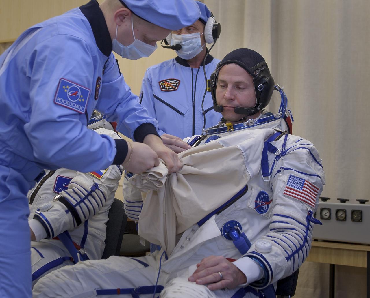 Flight Engineer Nick Hague of NASA dons his Sokol suits ahead of his launch on a Soyuz rocket with Flight Engineer Alexey Ovchinin of Roscosmos, Thursday, Oct. 11, 2018 at the Baikonur Cosmodrome in Kazakhstan. During the Soyuz spacecraft's climb to orbit, an anomaly occurred, resulting in an abort downrange. The crew was quickly recovered and is in good condition. Photo Credit: (NASA/GCTC/Irina Spector)