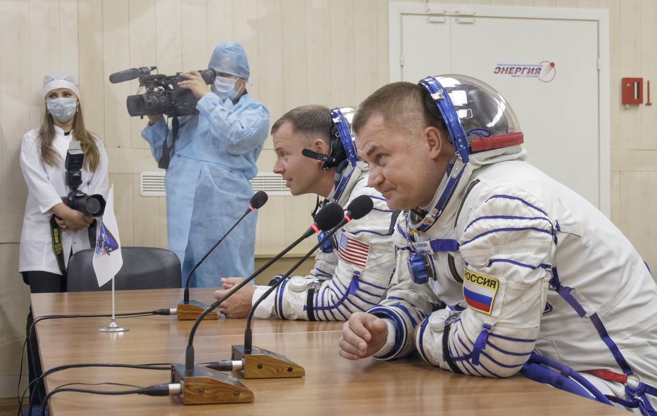 Expedition 57 Flight Engineer Nick Hague of NASA, left, and Flight Engineer Alexey Ovchinin of Roscosmos talk with their families after having their Sokol suits pressure checked ahead of their launch on a Soyuz rocket, Thursday, Oct. 11, 2018 at the Baikonur Cosmodrome in Kazakhstan. During the Soyuz spacecraft's climb to orbit, an anomaly occurred, resulting in an abort downrange. The crew was quickly recovered and is in good condition. Photo Credit: (NASA/Victor Zelentsov)