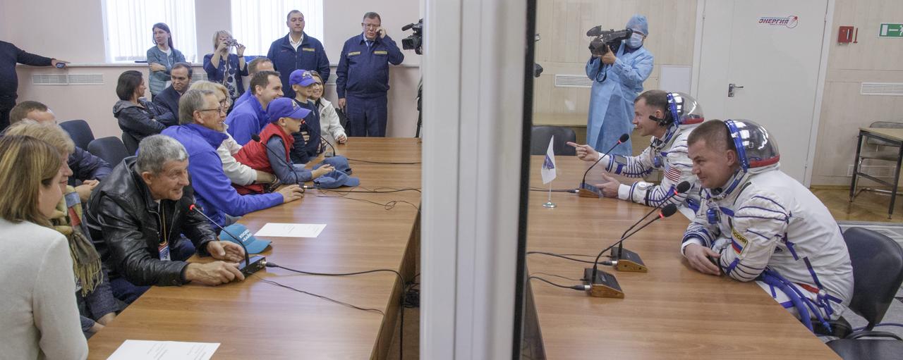 Expedition 57 Flight Engineer Nick Hague of NASA, left, and Flight Engineer Alexey Ovchinin of Roscosmos talk with their families after having their Sokol suits pressure checked for their launch on a Soyuz rocket, Thursday, Oct. 11, 2018 at the Baikonur Cosmodrome in Kazakhstan. During the Soyuz spacecraft's climb to orbit, an anomaly occurred, resulting in an abort downrange. The crew was quickly recovered and is in good condition. Photo Credit: (NASA/Victor Zelentsov)