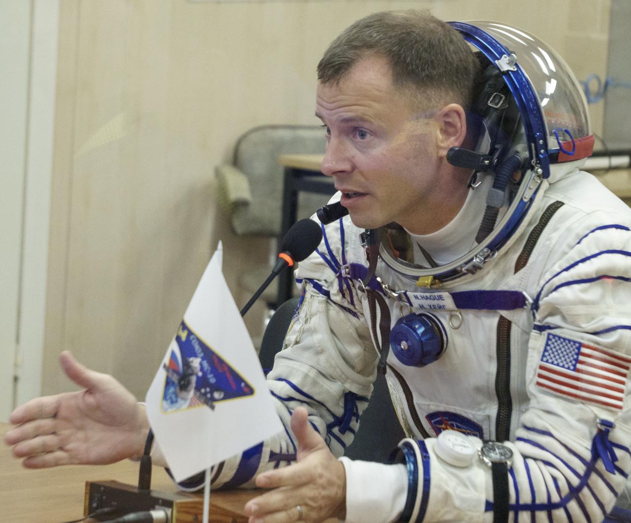 Expedition 57 Flight Engineer Nick Hague of NASA talks with his family after having his Sokol suit pressure checked ahead of his launch on a Soyuz rocket with Flight Engineer Alexey Ovchinin of Roscosmos, Thursday, Oct. 11, 2018 at the Baikonur Cosmodrome in Kazakhstan. During the Soyuz spacecraft's climb to orbit, an anomaly occurred, resulting in an abort downrange. The crew was quickly recovered and is in good condition. Photo Credit: (NASA/Victor Zelentsov)