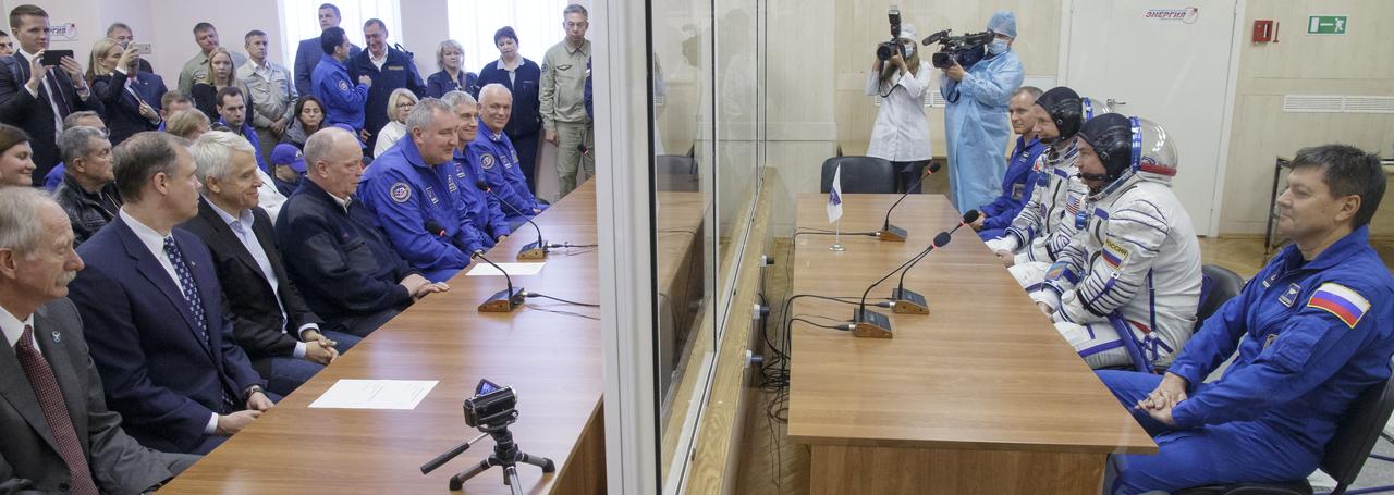 Expedition 57 prime crew members; Flight Engineer Nick Hague of NASA, space suit on seated left, and Flight Engineer Alexey Ovchinin of Roscosmos, space suit on seated right, along with, Expedition 57 backup crewmember David Saint-Jacques of the Canadian Space Agency, and Expedition 57 backup crewmember Oleg Kononenko of Roscosmos, far right, talk to NASA and Roscosmos management ahead of Hague and Ovchinin's launch on a Soyuz rocket, Thursday, Oct. 11, 2018 at the Baikonur Cosmodrome in Kazakhstan. During the Soyuz spacecraft's climb to orbit, an anomaly occurred, resulting in an abort downrange. The crew was quickly recovered and is in good condition. Photo Credit: (NASA/Victor Zelentsov)