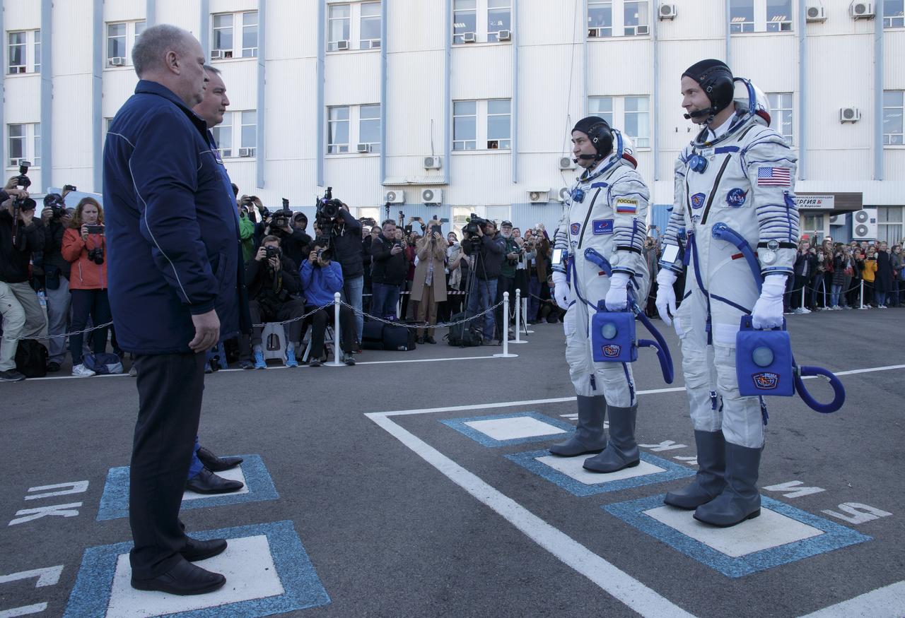 Expedition 57 Flight Engineer Alexey Ovchinin of Roscosmos, left, and Flight Engineer Nick Hague of NASA report to Roscosmos management as they depart building 254 for their launch on a Soyuz rocket, Thursday, Oct. 11, 2018 at the Baikonur Cosmodrome in Kazakhstan. During the Soyuz spacecraft's climb to orbit, an anomaly occurred, resulting in an abort downrange. The crew was quickly recovered and is in good condition. Photo Credit: (NASA/Victor Zelentsov)