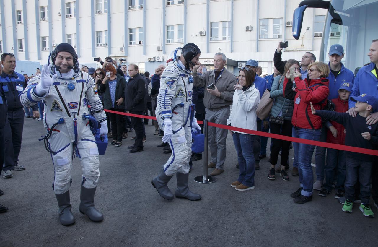 Expedition 57 Flight Engineer Alexey Ovchinin of Roscosmos, left, and Flight Engineer Nick Hague of NASA say farewell to family as they depart building 254 for their launch on a Soyuz rocket, Thursday, Oct. 11, 2018 at the Baikonur Cosmodrome in Kazakhstan. During the Soyuz spacecraft's climb to orbit, an anomaly occurred, resulting in an abort downrange. The crew was quickly recovered and is in good condition. Photo Credit: (NASA/Victor Zelentsov)