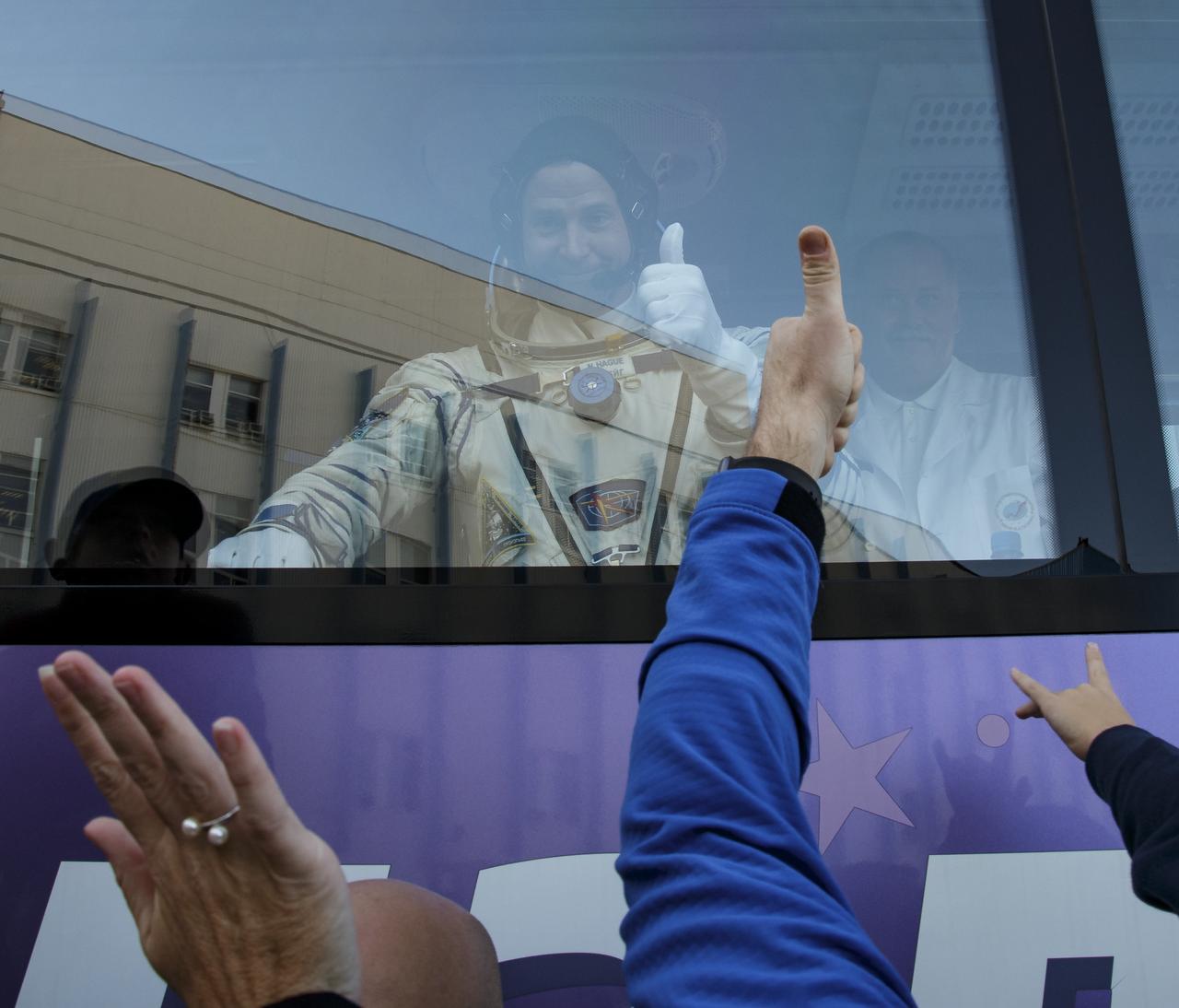 Expedition 57 Flight Engineer Nick Hague of NASA waves farewell to family and friends as he departs building 254 for launch on a Soyuz rocket with Flight Engineer Alexey Ovchinin of Roscosmos, Thursday, Oct. 11, 2018 at the Baikonur Cosmodrome in Kazakhstan. During the Soyuz spacecraft's climb to orbit, an anomaly occurred, resulting in an abort downrange. The crew was quickly recovered and is in good condition. Photo Credit: (NASA/Victor Zelentsov)