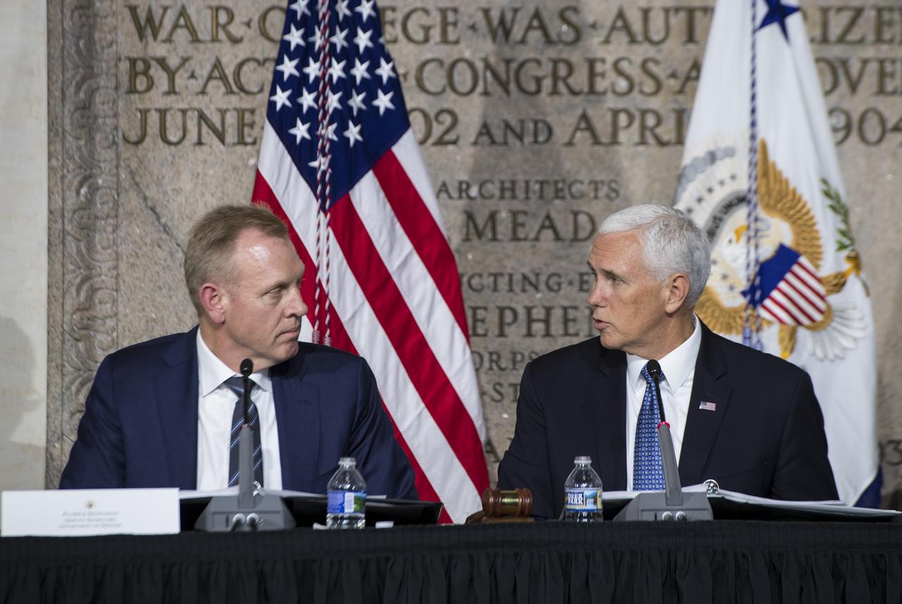 Vice President Mike Pence, right, speaks to Patrick Shanahan, deputy secretary, Department of Defense, during the National Space Council meeting titled, Moon, Mars, and Worlds Beyond, Winning the Next Frontier, Tuesday, Oct. 23, 2018 at the National War College at Fort Lesley J. McNair in Washington. Chaired by the Vice President, the council's role is to advise the President regarding national space policy and strategy, and review the nation's long-range goals for space activities.Photo Credit: (NASA/Aubrey Gemignani)