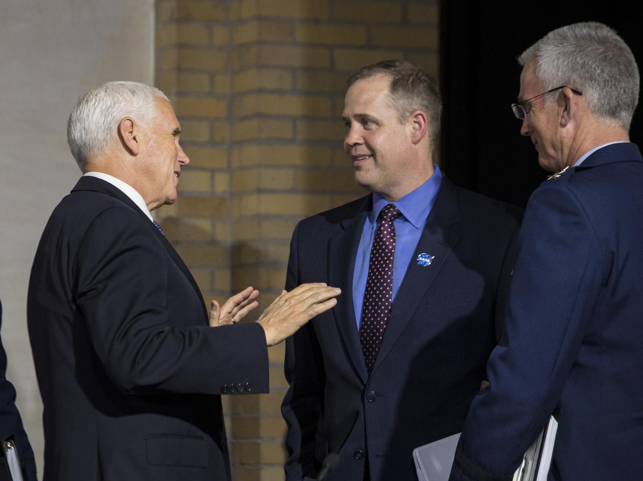 Vice President Mike Pence speaks with NASA Administrator Jim Bridenstine, right, at the conclusion of a National Space Council meeting titled, Moon, Mars, and Worlds Beyond, Winning the Next Frontier, at the National War College at Fort Lesley J. McNair, Tuesday, Oct. 23, 2018, in Washington. Chaired by the Vice President, the council's role is to advise the President regarding national space policy and strategy, and review the nation's long-range goals for space activities. Photo Credit: (NASA/Aubrey Gemignani)