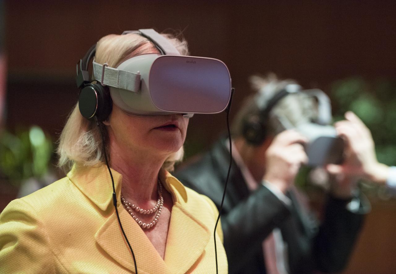 A guest uses some virtual reality viewers before a showing of the Project Mars Competition's short films winners and the Mars series, Monday, November 5, 2018 at National Geographic Society Headquarters in Washington. Photo Credit: (NASA/Aubrey Gemignani)