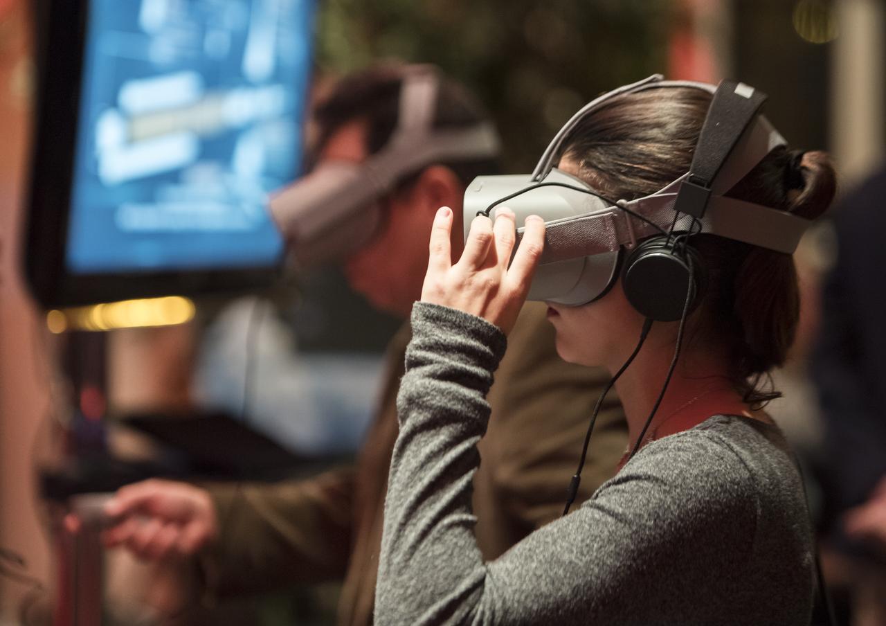 A guest uses some virtual reality viewers before a showing of the Project Mars Competition's short films winners and the Mars series, Monday, November 5, 2018 at National Geographic Society Headquarters in Washington. Photo Credit: (NASA/Aubrey Gemignani)
