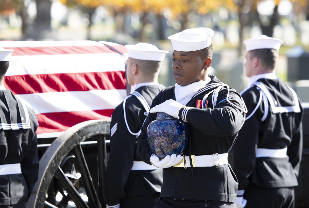 A member of the U.S. Navy Honor Guard carries the urn containing the ashes of former astronaut Alan Bean during interment services, Thursday, Nov. 8, 2018 at Arlington National Cemetery in Virginia. Selected as an astronaut in 1963, Bean flew in space twice, becoming the fourth human to walk on the Moon on Nov. 19, 1969 and spent 59 days in space as commander of the second Skylab mission in 1973. Photo Credit: (NASA/Joel Kowsky)