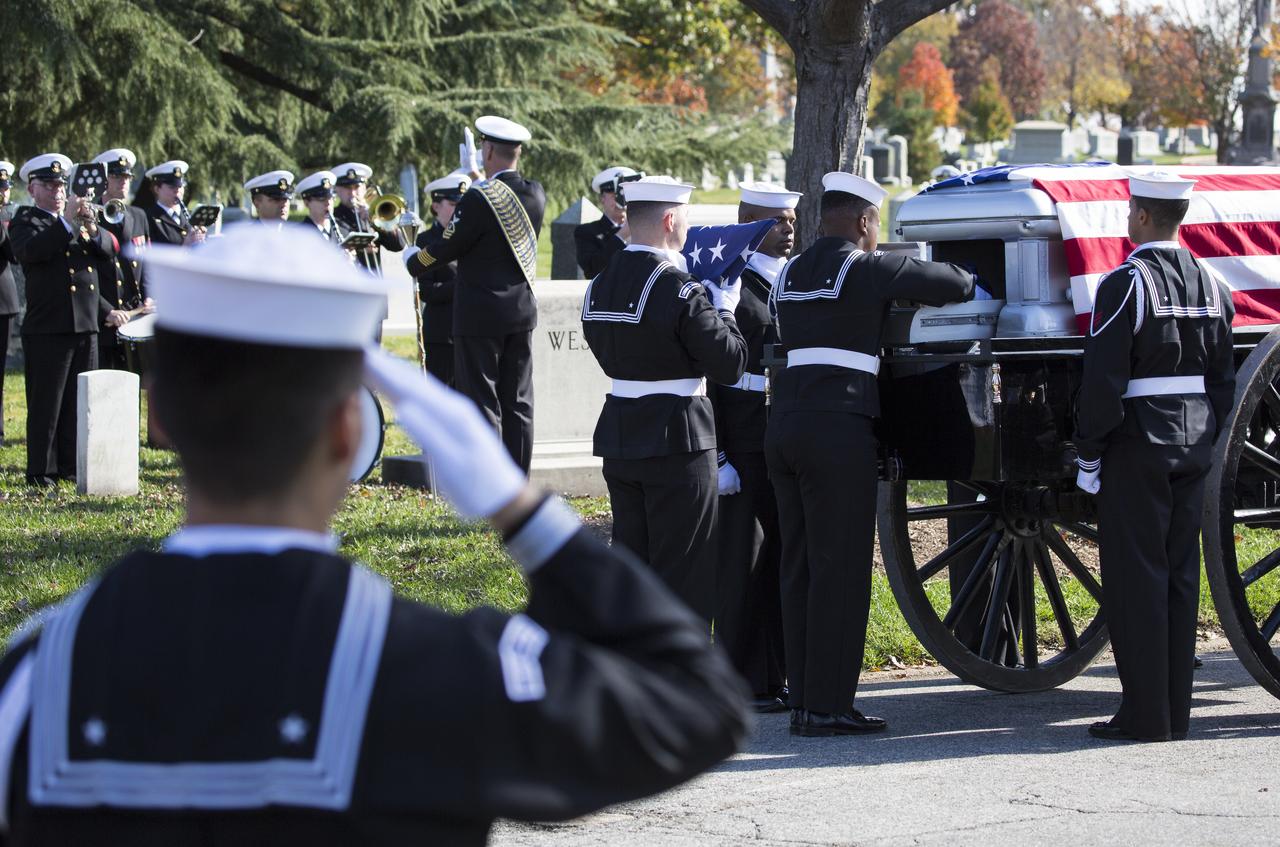 A U.S. Navy Honor Guard places the urn containing the ashes of former astronaut Alan Bean on the horse drawn caisson during interment services, Thursday, Nov. 8, 2018 at Arlington National Cemetery in Virginia. Selected as an astronaut in 1963, Bean flew in space twice, becoming the fourth human to walk on the Moon on Nov. 19, 1969 and spent 59 days in space as commander of the second Skylab mission in 1973. Photo Credit: (NASA/Joel Kowsky)