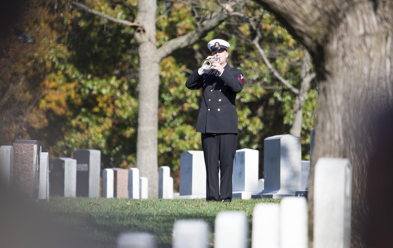 U.S. Navy Musician First Class Ben Hauser plays taps during the interment services for former astronaut Alan Bean, Thursday, Nov. 8, 2018 at Arlington National Cemetery in Virginia. Selected as an astronaut in 1963, Bean flew in space twice, becoming the fourth human to walk on the Moon on Nov. 19, 1969 and spent 59 days in space as commander of the second Skylab mission in 1973. Photo Credit: (NASA/Joel Kowsky)