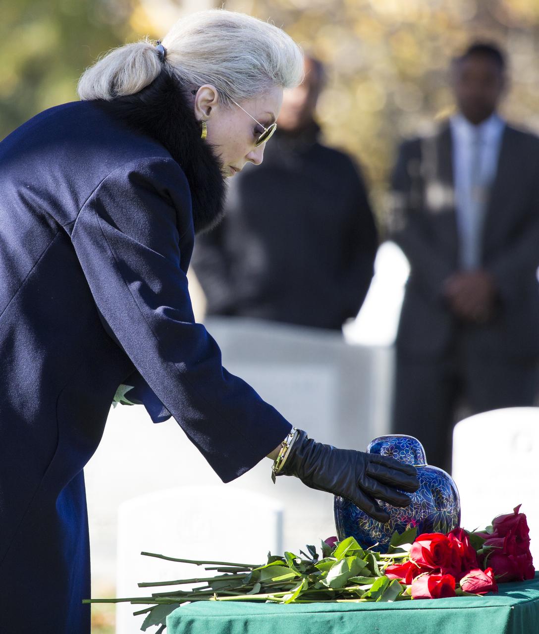 Leslie Bean, wife of former astronaut Alan Bean, places her hand on the urn containing his ashes, Thursday, Nov. 8, 2018 at Arlington National Cemetery in Virginia. Selected as an astronaut in 1963, Bean flew in space twice, becoming the fourth human to walk on the Moon on Nov. 19, 1969 and spent 59 days in space as commander of the second Skylab mission in 1973. Photo Credit: (NASA/Joel Kowsky)