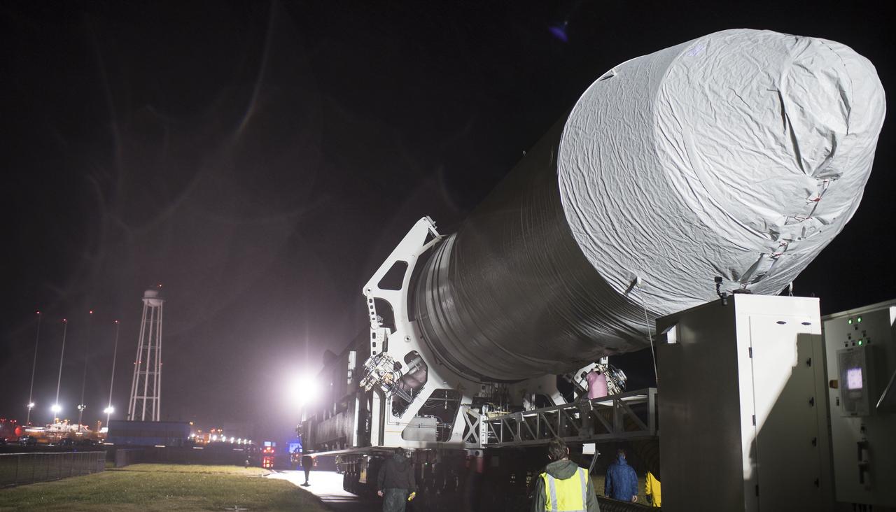 A Northrop Grumman Antares rocket is seen as it is rolled from the Horizontal Integration Facility (HIF) to Pad-0A, Monday, Nov. 12, 2018 at NASA's Wallops Flight Facility in Virginia. Northrop Grumman's 10th contracted cargo resupply mission for NASA to the International Space Station will deliver about 7,500 pounds of science and research, crew supplies and vehicle hardware to the orbital laboratory and its crew. Launch is scheduled for Nov. 15 at 4:49 a.m. EST. Photo Credit: (NASA/Joel Kowsky)