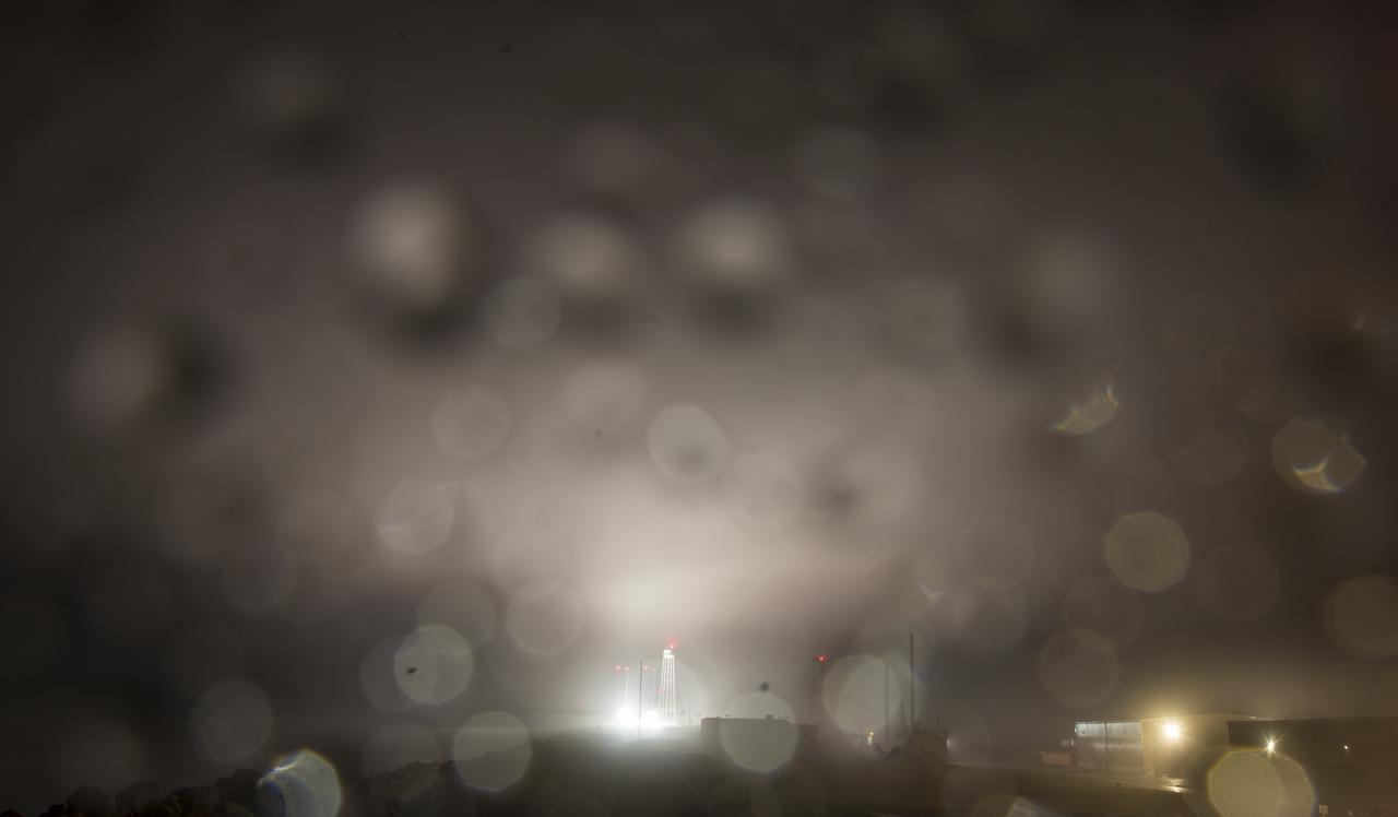 Pad-0A is seen illuminated by lights as work continues to raise the Northrop Grumman Antares rocket into a vertical position on the launch pad, Tuesday, Nov. 13, 2018 at NASA's Wallops Flight Facility in Virginia. Northrop Grumman's 10th contracted cargo resupply mission for NASA to the International Space Station will deliver about 7,500 pounds of science and research, crew supplies and vehicle hardware to the orbital laboratory and its crew. Launch is scheduled for Nov. 15 at 4:49 a.m. EST. Photo Credit: (NASA/Joel Kowsky)